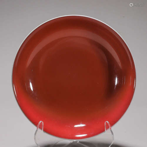 A deep red glazed porcelain plate