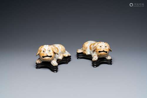 A PAIR OF CHINESE PORCELAIN MODELS OF RECLINING DOGS, QIANLO...