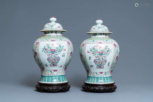 A PAIR OF CHINESE FAMILLE ROSE VASES AND COVERS, 19TH C.