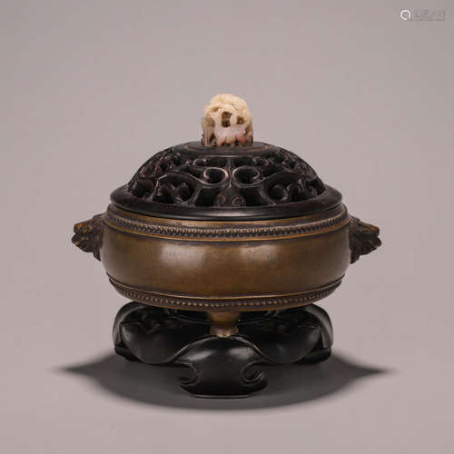 A copper censer with lion head shaped ears