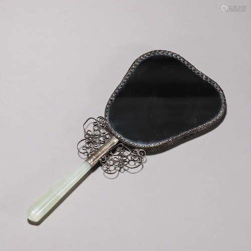 A silver mirror with jade handle