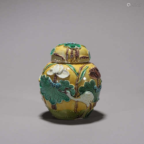 A carved tri-colored porcelain covered jar