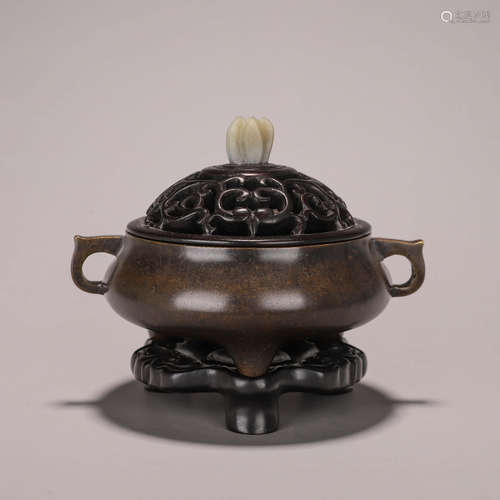 A three-legged copper censer with dragon shaped ears