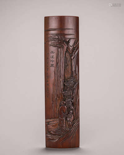 A carved bamboo arm rest