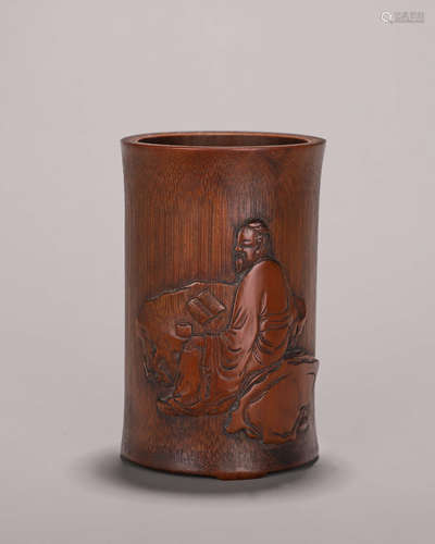 A carved bamboo brush pot