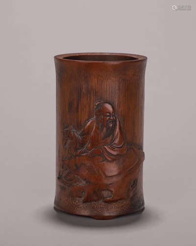 A carved bamboo brush pot