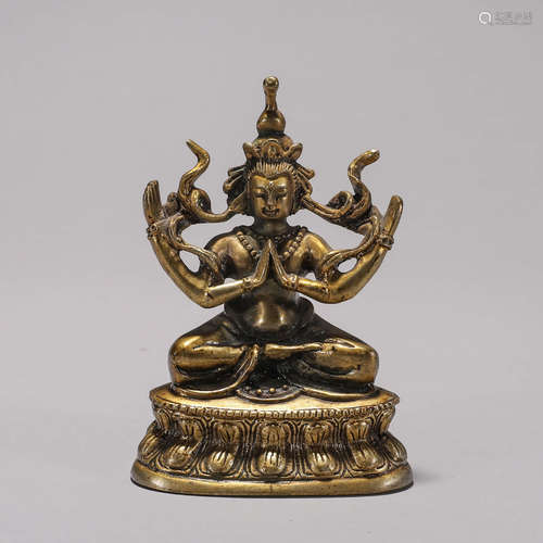 A copper four-armed buddha statue