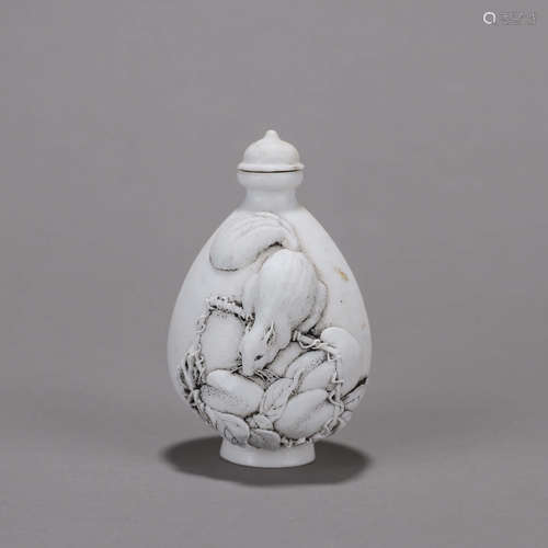 A carved squirrel porcelain snuff bottle