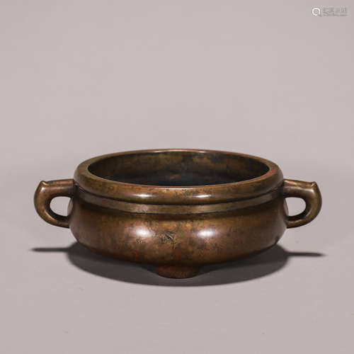 A three-legged copper censer with dragon shaped ears