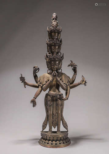 A copper eight-armed Guanyin statue