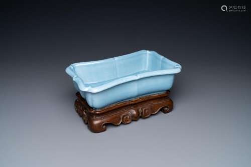 A CHINESE MONOCHROME LAVENDER BLUE JARDINIERE ON WOODEN STAN...