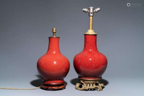 TWO CHINESE MONOCHROME SANG DE BOEUF-GLAZED BOTTLE VASES TRA...