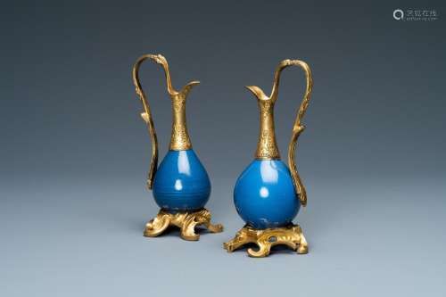 TWO CHINESE MONOCHROME BLUE VASES MOUNTED AS EWERS WITH GILT...