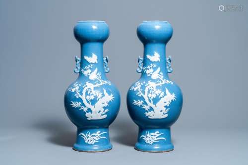A PAIR OF CHINESE WHITE SLIP-DECORATED BLUE-GROUND VASES, 19...