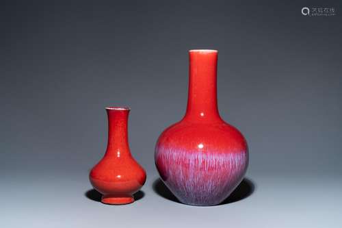 TWO CHINESE MONOCHROME SANG DE BOEUF-GLAZED BOTTLE VASES, 19...