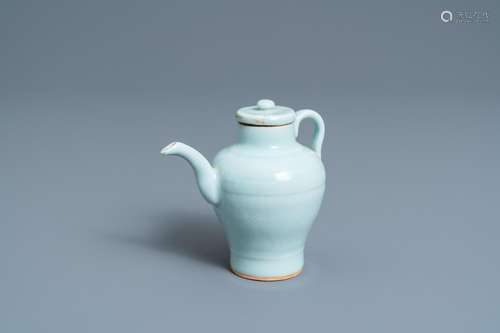 A CHINESE MONOCHROME CELADON-GLAZED EWER AND COVER WITH INCI...