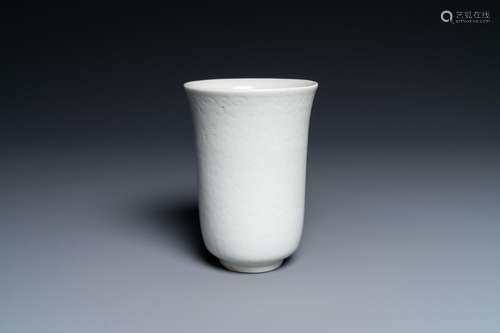 A CHINESE WHITE-GLAZED ANHUA-DECORATED 'PEONY' CUP...