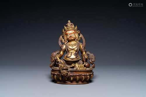 A SINO-TIBETAN PARTLY GILT BRONZE FIGURE OF JAMBHALA WITH IN...