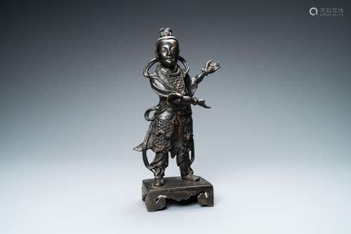 A CHINESE BRONZE FIGURE OF A SERVANT, MING