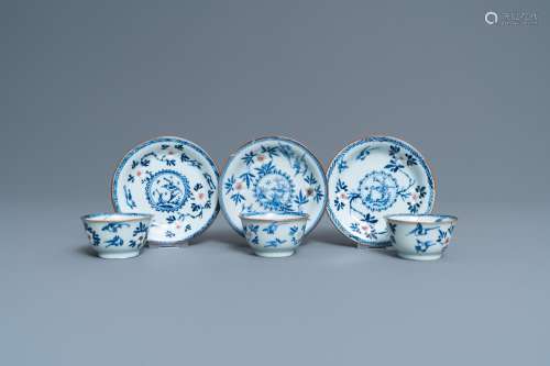 THREE CHINESE BLUE, WHITE AND COPPER-RED CUPS AND SAUCERS, K...