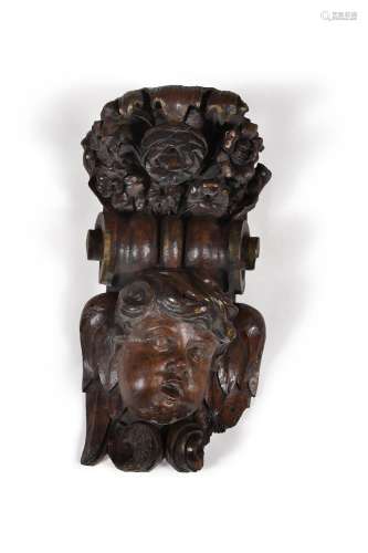 A CHARLES II CARVED WALNUT MASK WALL MOUNT IN BAROQUE MANNER...