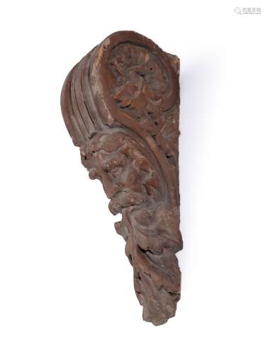 A GEORGE II CARVED WOOD AND PAINTED MASK CORBEL OR WALL MOUN...