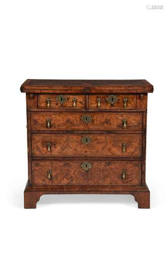 A GEORGE II FIGURED WALNUT AND FEATHER BANDED BACHELOR'...