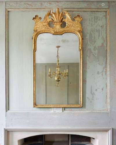 A GEORGE I GILTWOOD AND GESSO WALL MIRROR IN THE MANNER OF M...