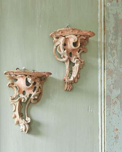 A PAIR OF GEORGE II CARVED SOFT WOOD WALL BRACKETS IN THE MA...