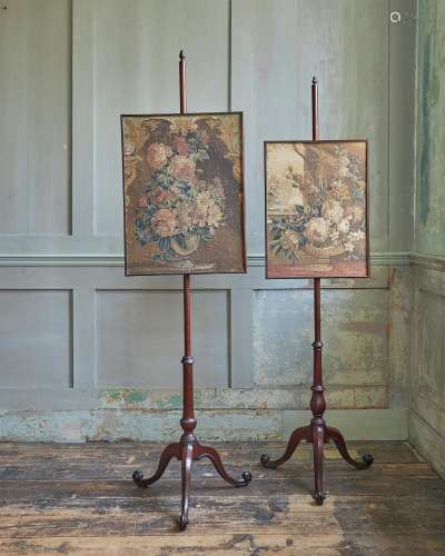 A NEAR PAIR OF GEORGE III MAHOGANY POLE SCREENS, IN THE MANN...