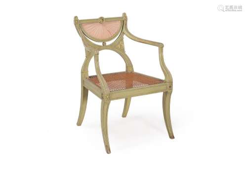 A PAINTED AND PARCEL GILT OPEN ARMCHAIR, AFTER A DESIGN BY G...