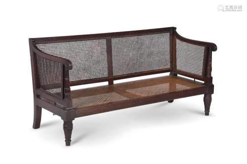 A REGENCY MAHOGANY AND CANED BERGÈRE SETTEE, IN THE MANNER O...