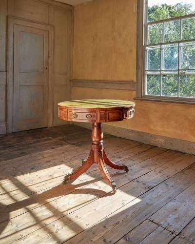 A REGENCY MAHOGANY DRUM LIBRARY TABLE, IN THE MANNER JOHN MC...