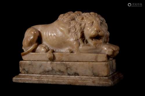 AN ITALIAN CARVED MARBLE MODEL OF A RECUMBENT LION AFTER ANT...