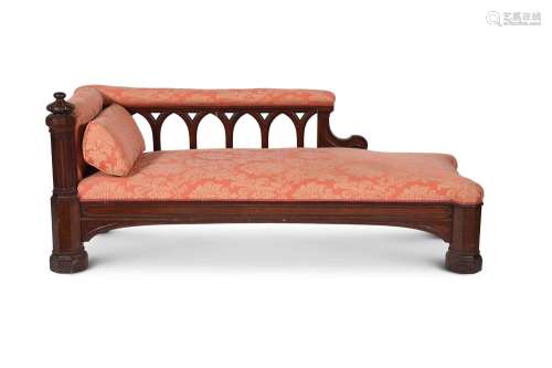 A GOTHIC REVIVAL MAHOGANY AND UPHOLSTERED DAYBED, IN THE MAN...