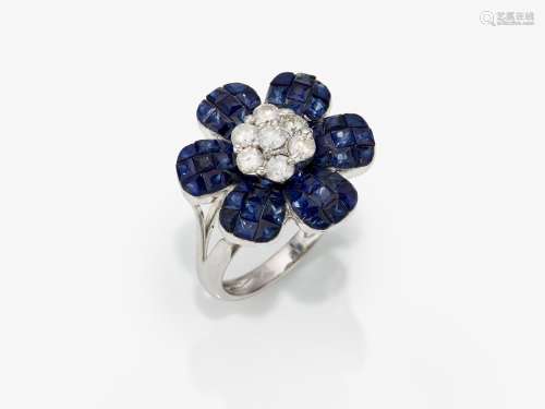 A floral cocktail ring decorated with sapphires and brillian...