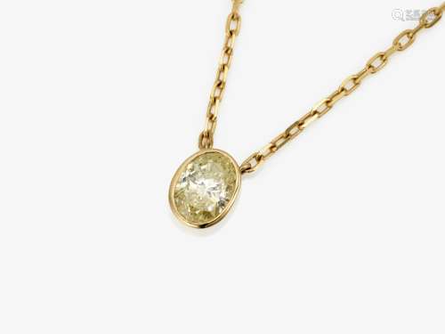 A pendant necklace with an oval diamond solitaire in fancy y...