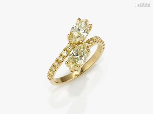 A Vis a Vis ring decorated with soft yellow diamonds in marq...