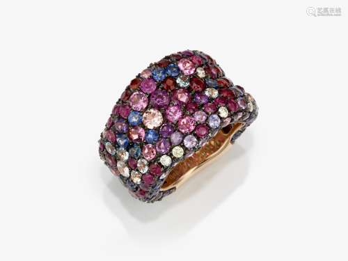 A modern band ring studded with sapphires, tourmalines, rubi...