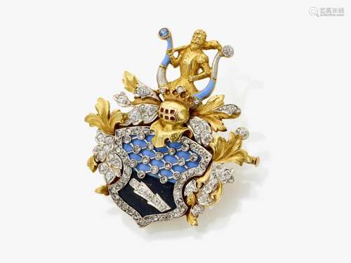 A brooch in the shape of a coat of arms with crest