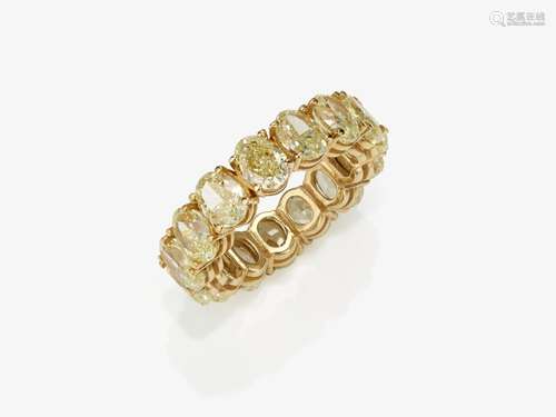 An eternity band ring decorated with oval diamonds in fancy ...