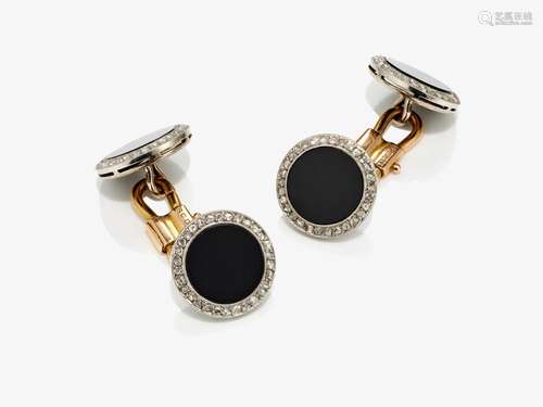 A pair of cufflinks with onyx and diamond roses