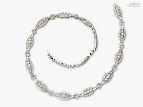 An elegant link necklace decorated with brilliant and baguet...