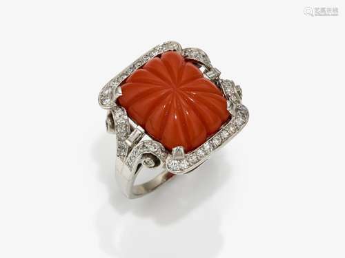 A ring with coral and diamonds