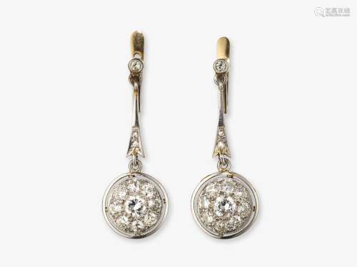 A pair of earrings with diamonds
