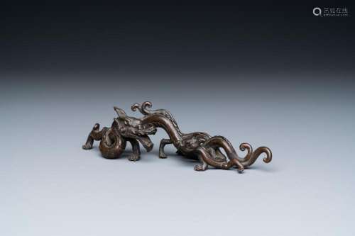 A RARE CHINESE BRONZE 'DRAGON' BRUSH REST, YUAN/MING