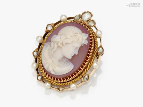A brooch with an engraved gem, diamonds and pearls