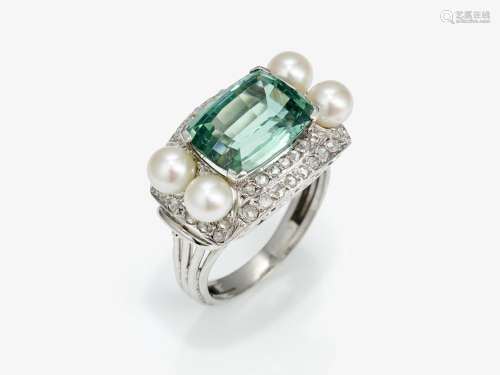 A ring with blue-green tourmaline, diamonds and cultured pea...
