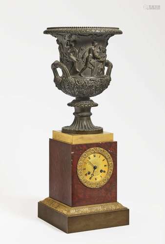 A pendulum clock with a Medici krater vase