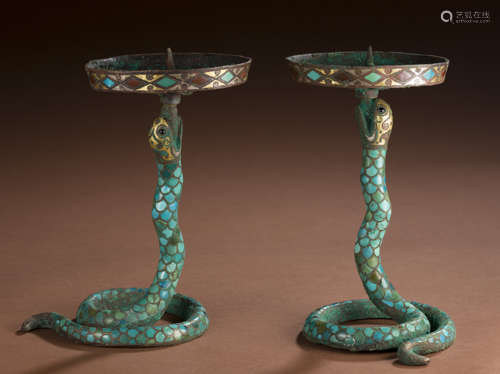 Ancient bronze and gold studded serpentine candlestick